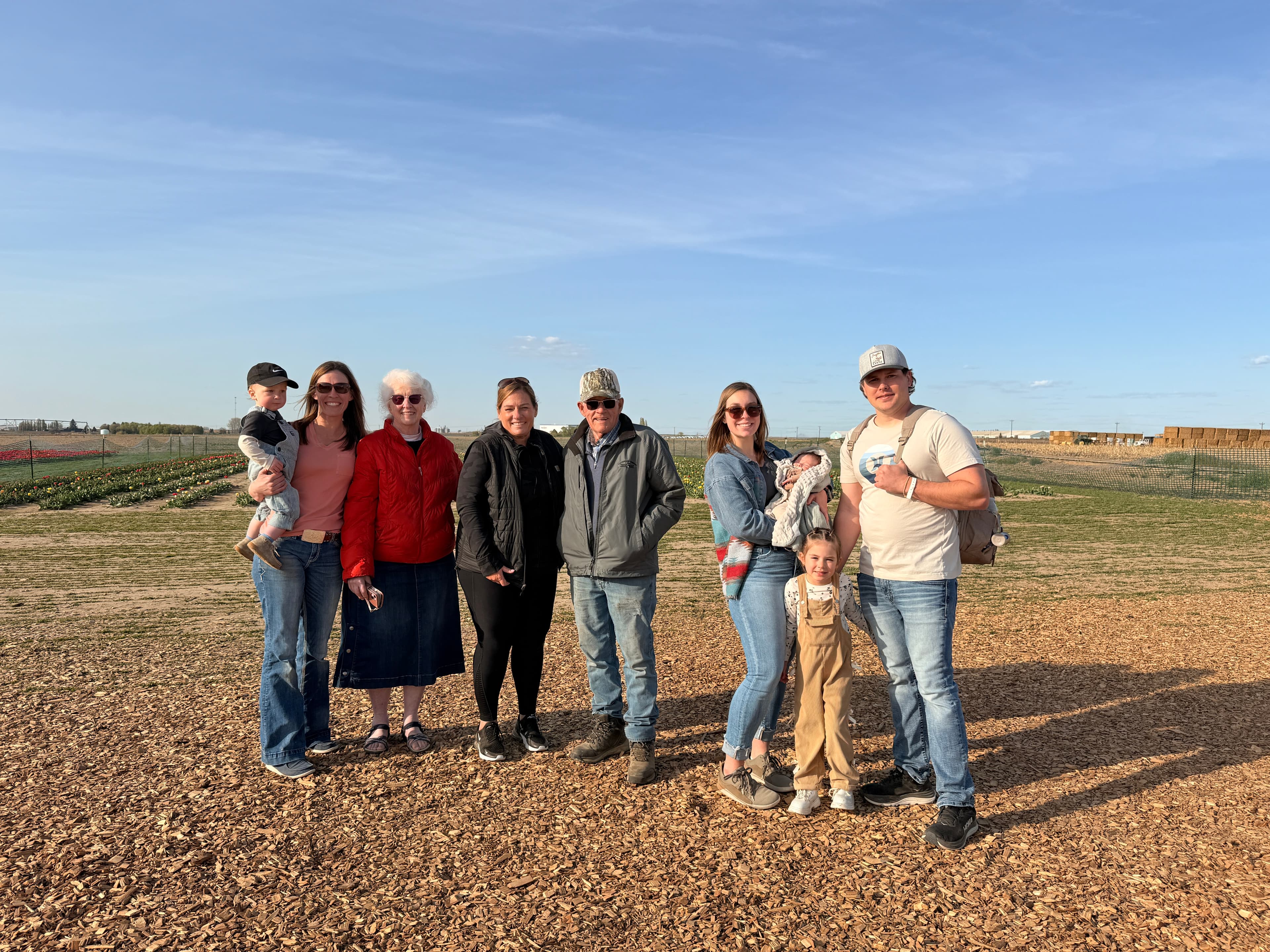 Darci with a large family group at a farm